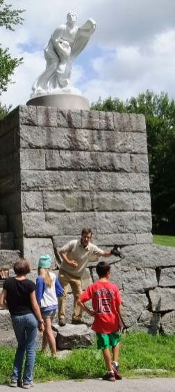 Sandwich Historical Society director Adam Nudd-Homeyer acts out the 1941 collapse of the recently restored "Niobe" statue on the Great Wall of Sandwich...